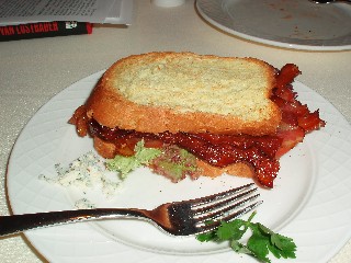 Brioche toast with blue cheese and lettuce and tomato and bacon and toast press sandwich